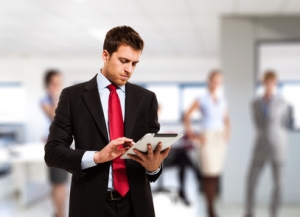 Businessman using his tablet